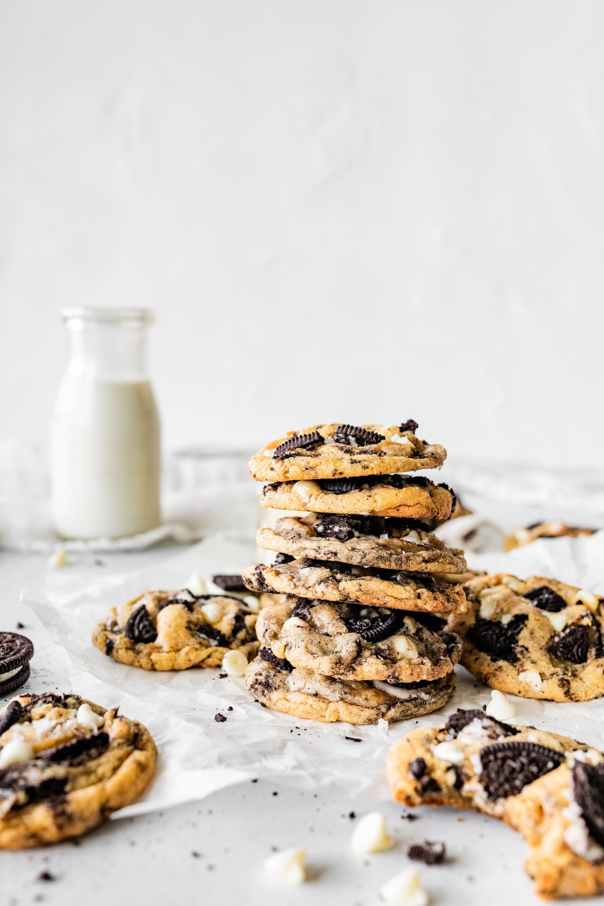 stack of cookies and cream cookies with bottle of milk. 