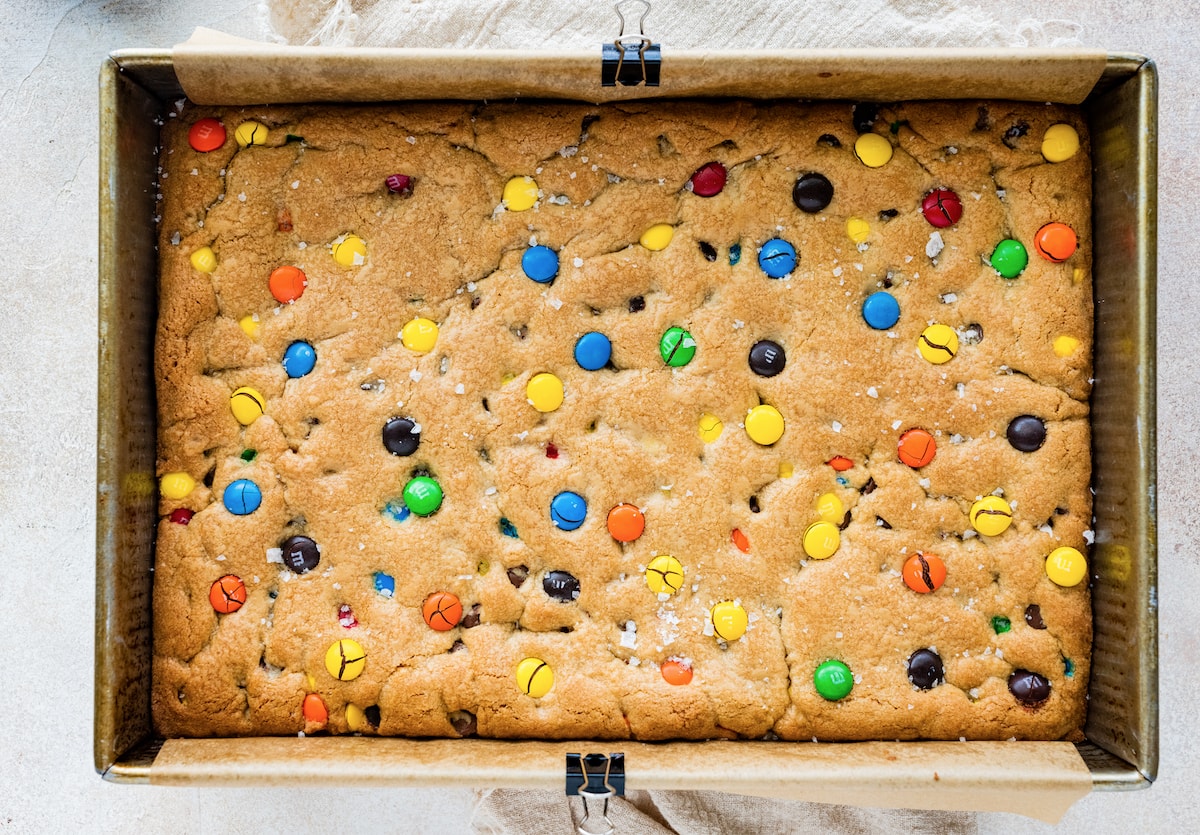 baked M&M cookie bars in pan. 