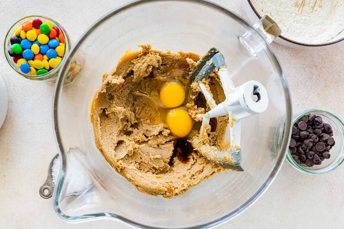 creaming butter and sugars in a mixing bowl with beater blade and adding eggs and vanilla. 