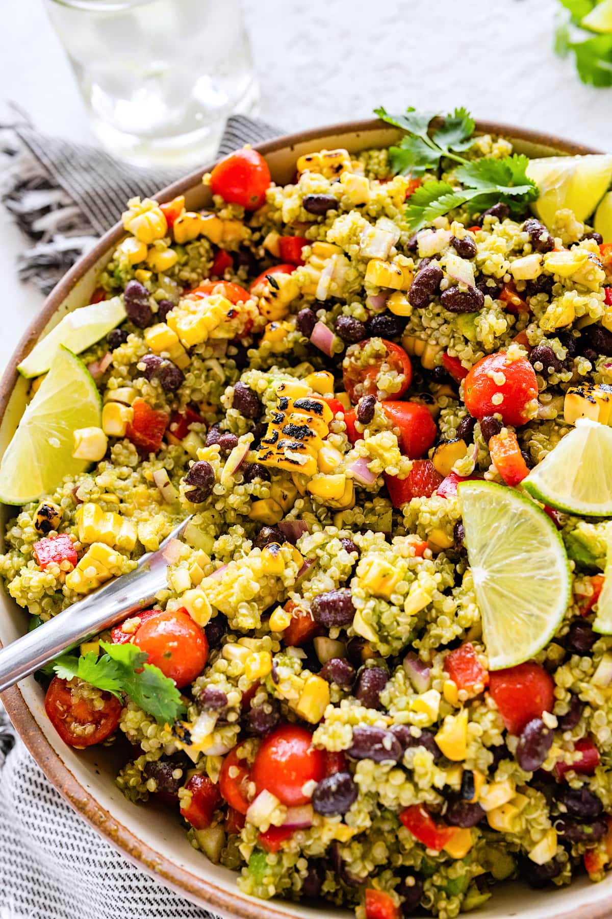 southwest quinoa salad in serving bowl with spoon. 