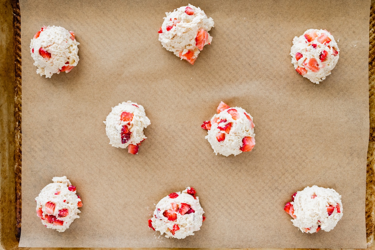 strawberry biscuits on baking sheet ready to go in the oven. 