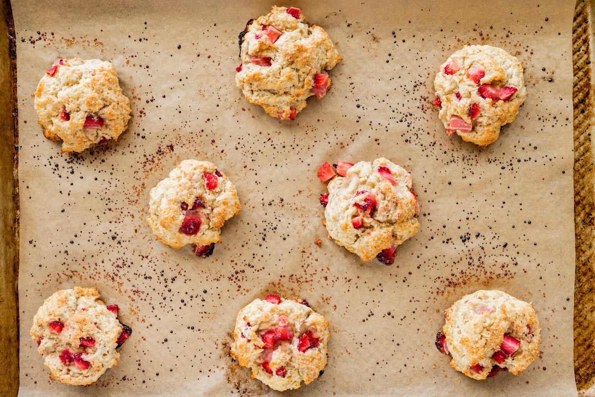 strawberry biscuits on baking sheet with parchment paper. 