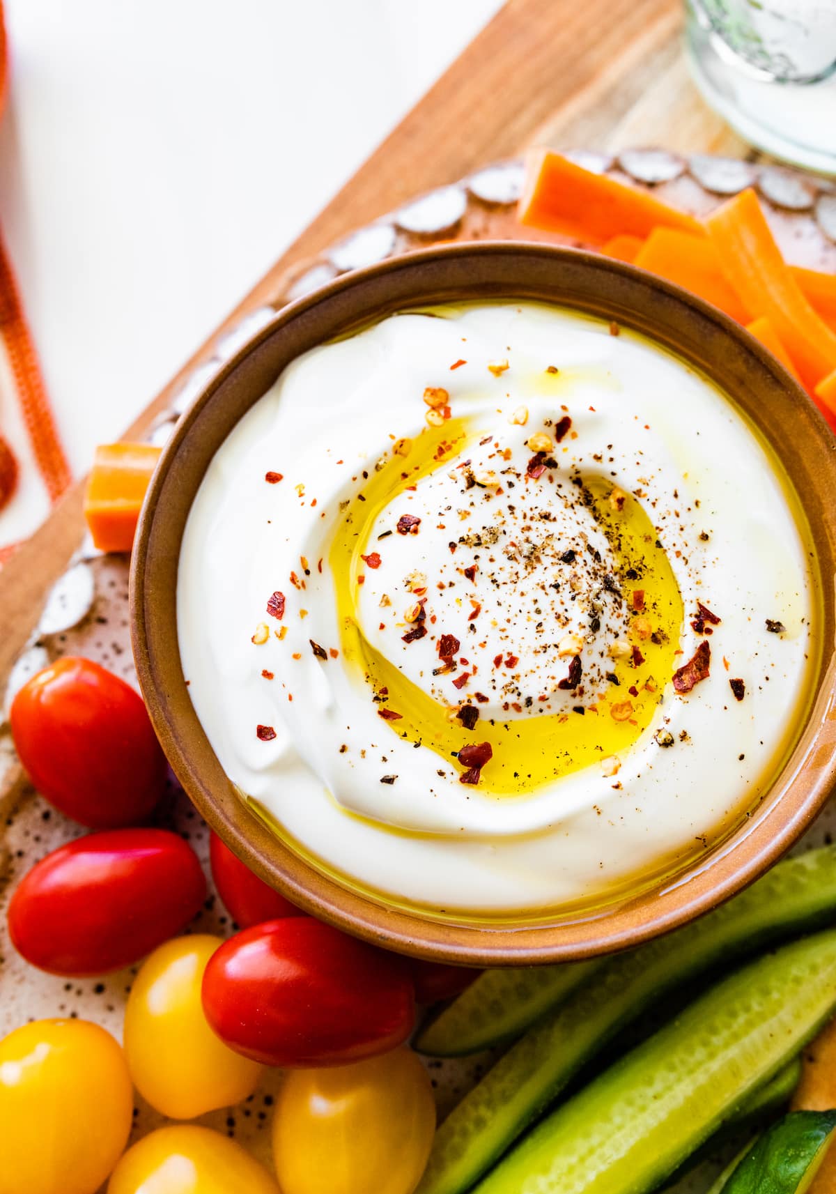 whipped cottage cheese in bowl with olive oil and crushed red pepper flakes. 