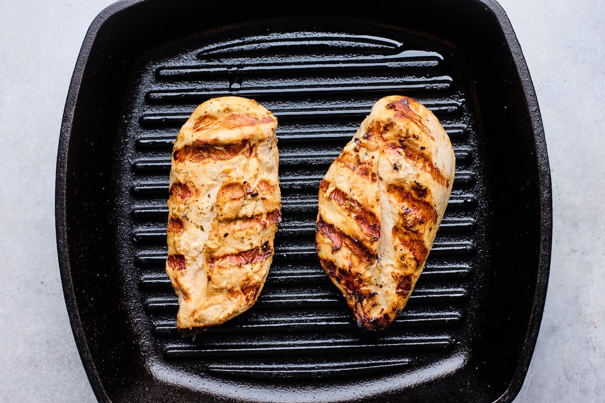 chicken breasts being grilled on cast iron grill pan. 