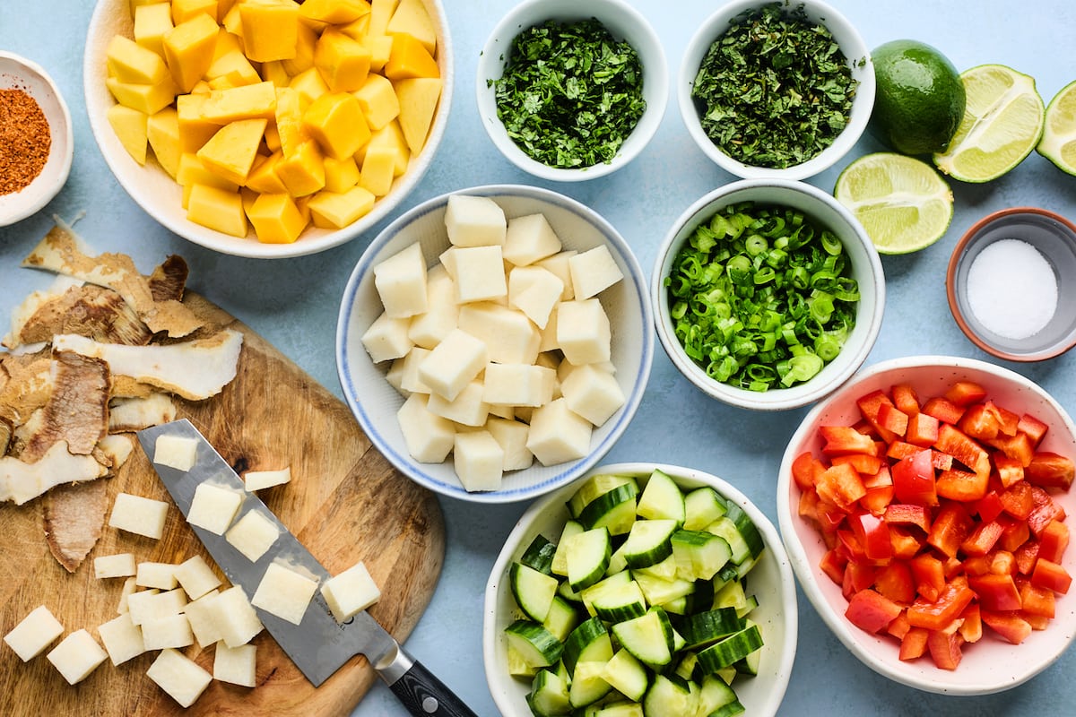 mango salad ingredients in bowls. 