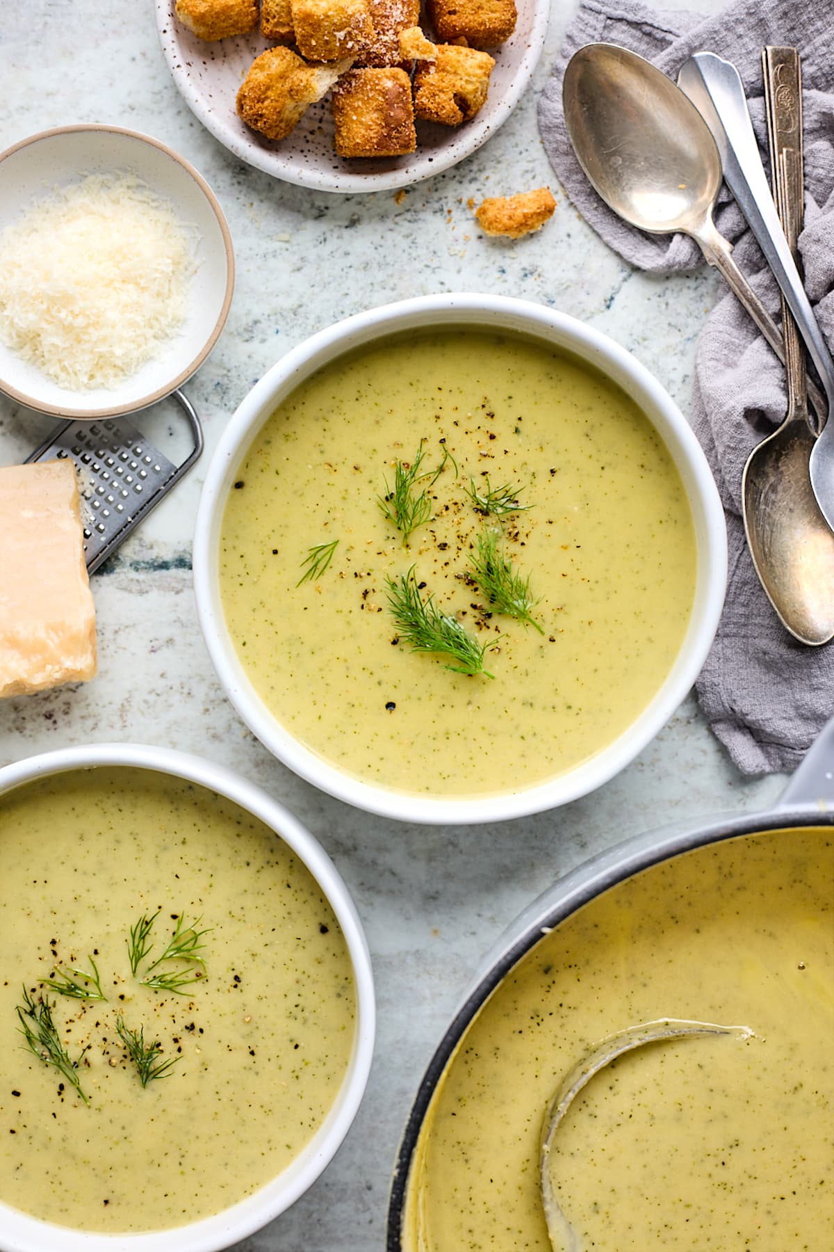 zucchini soup in bowls with black pepper and dill. 