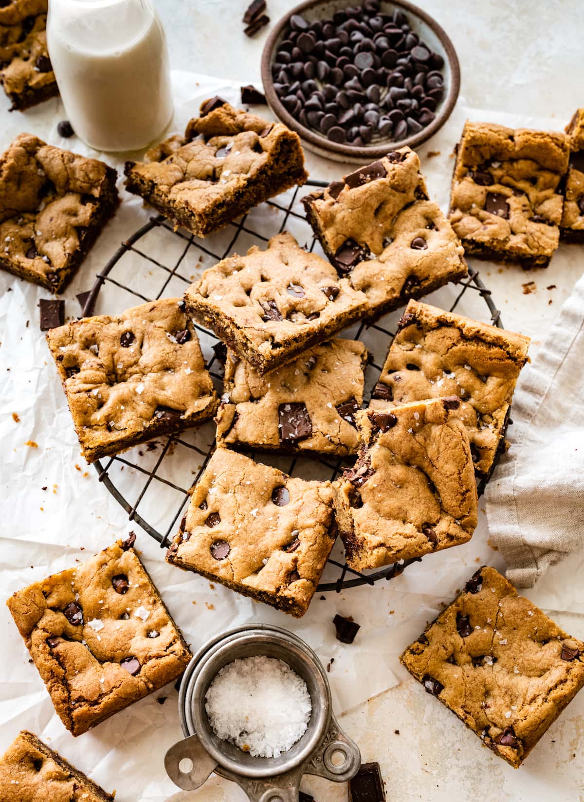 brown butter chocolate chip cookie bars cut into squares on wire cooling rack. 