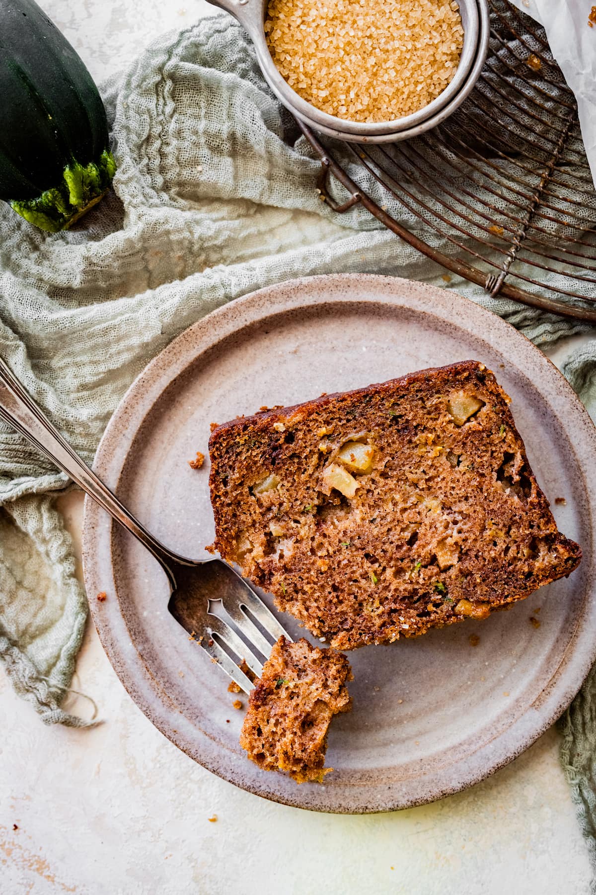 piece of apple zucchini bread on plate with fork. 