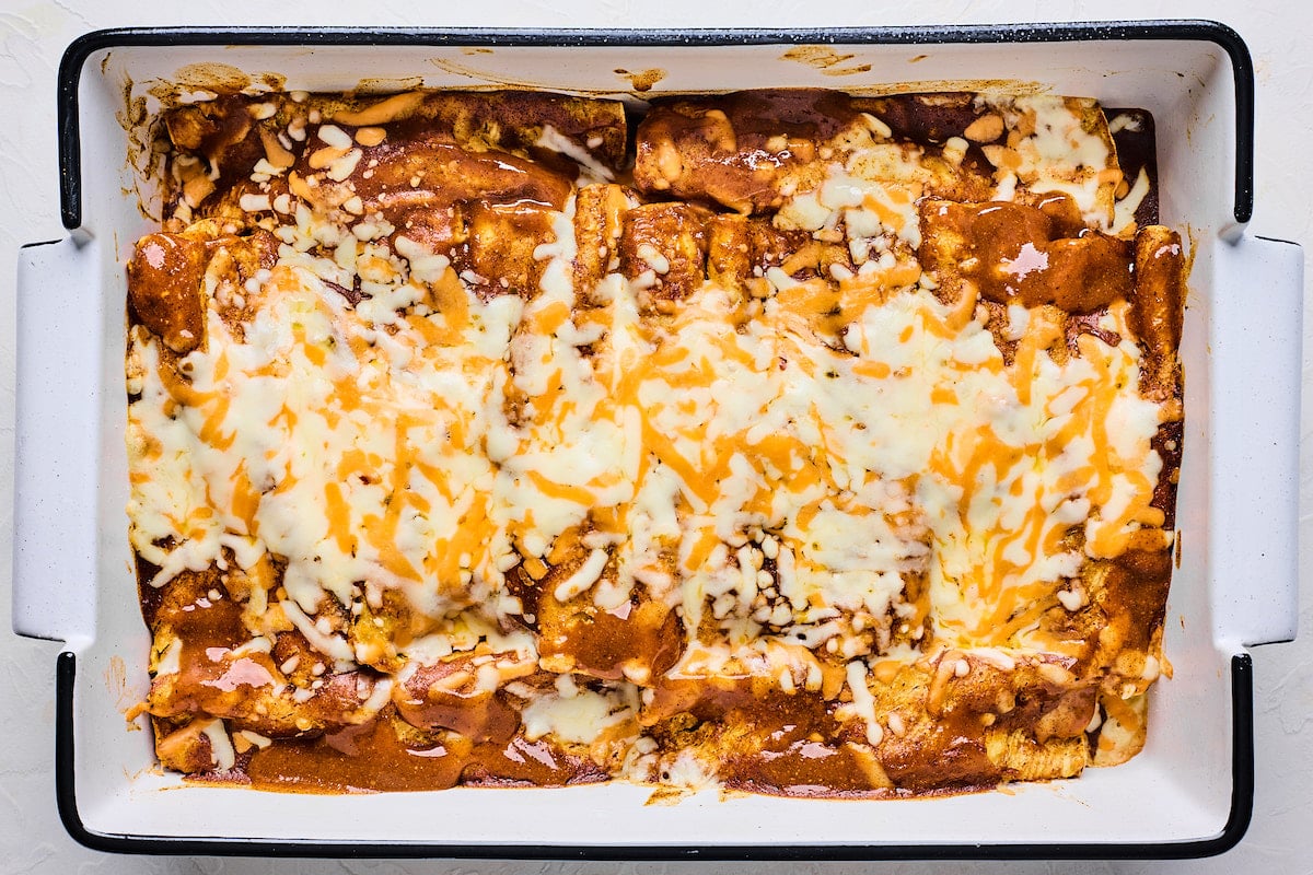 cauliflower enchiladas in pan with melted cheese. 