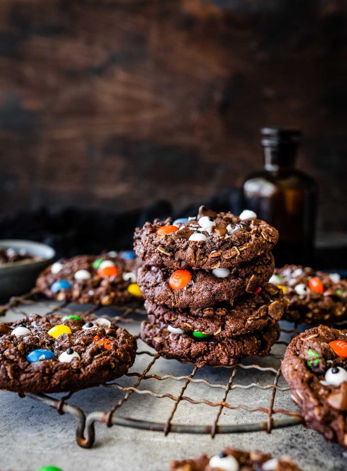 stack of chocolate monster cookies on cooling rack. 