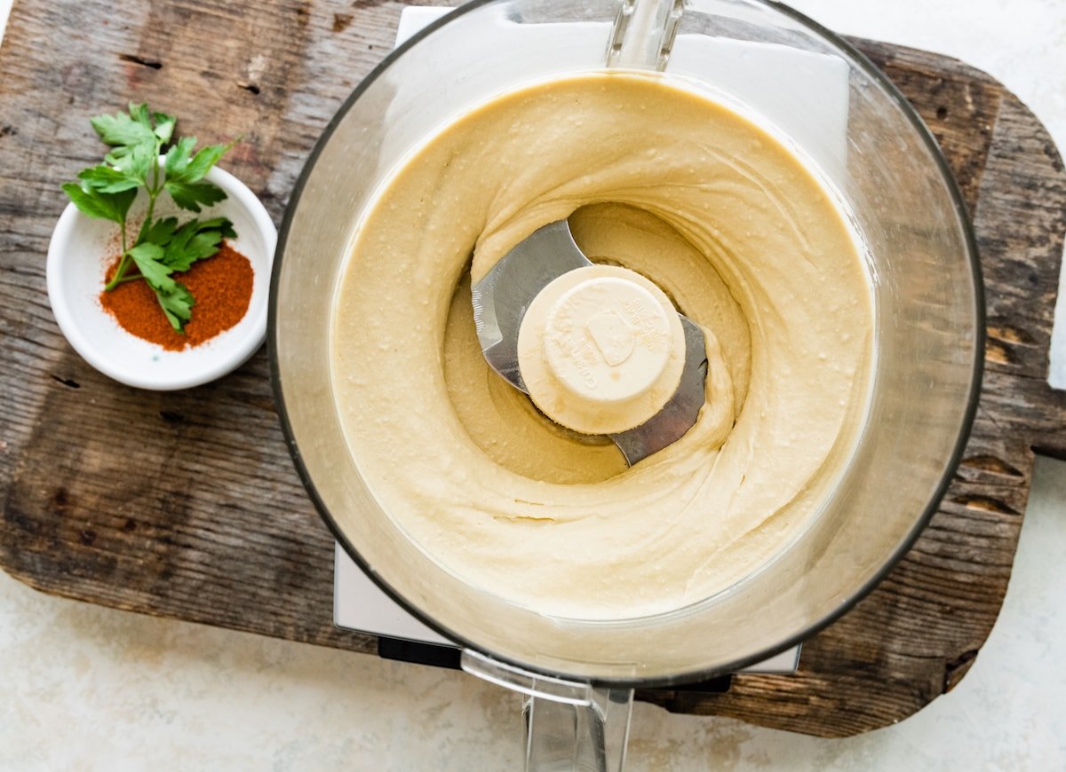 creamy hummus in food processor. 