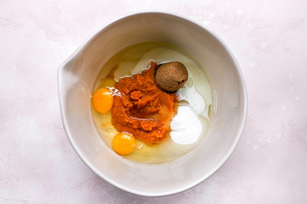 sugar, brown sugar, pumpkin, eggs, and vanilla in mixing bowl to make pumpkin chocolate chip muffins. 