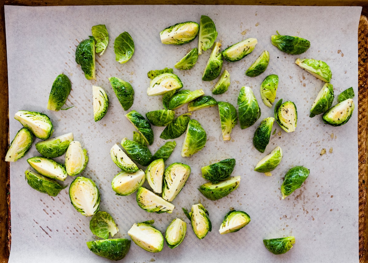 roasted brussels sprouts on baking sheet with parchment paper. 