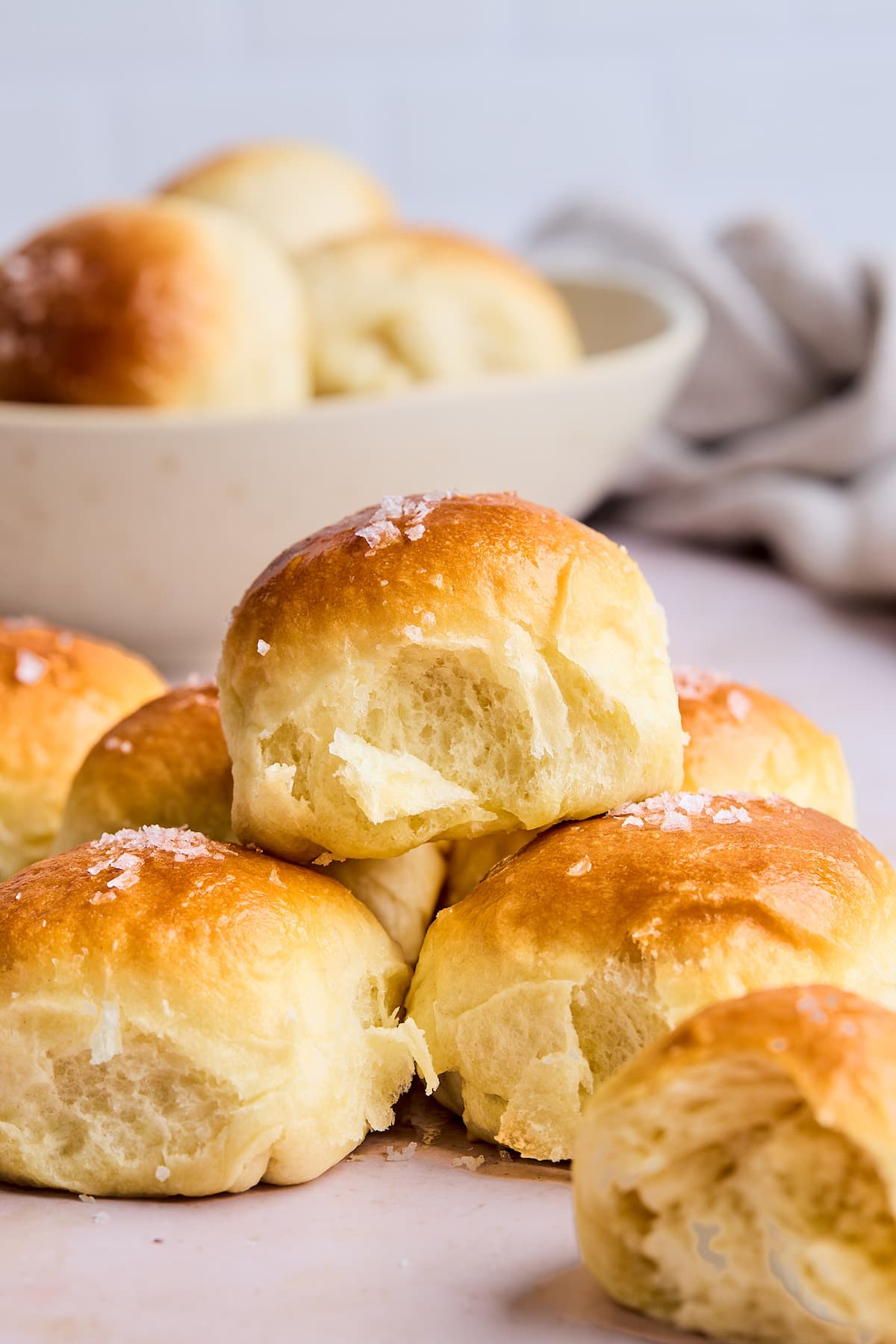 flaky dinner rolls stacked with butter and sea salt. 