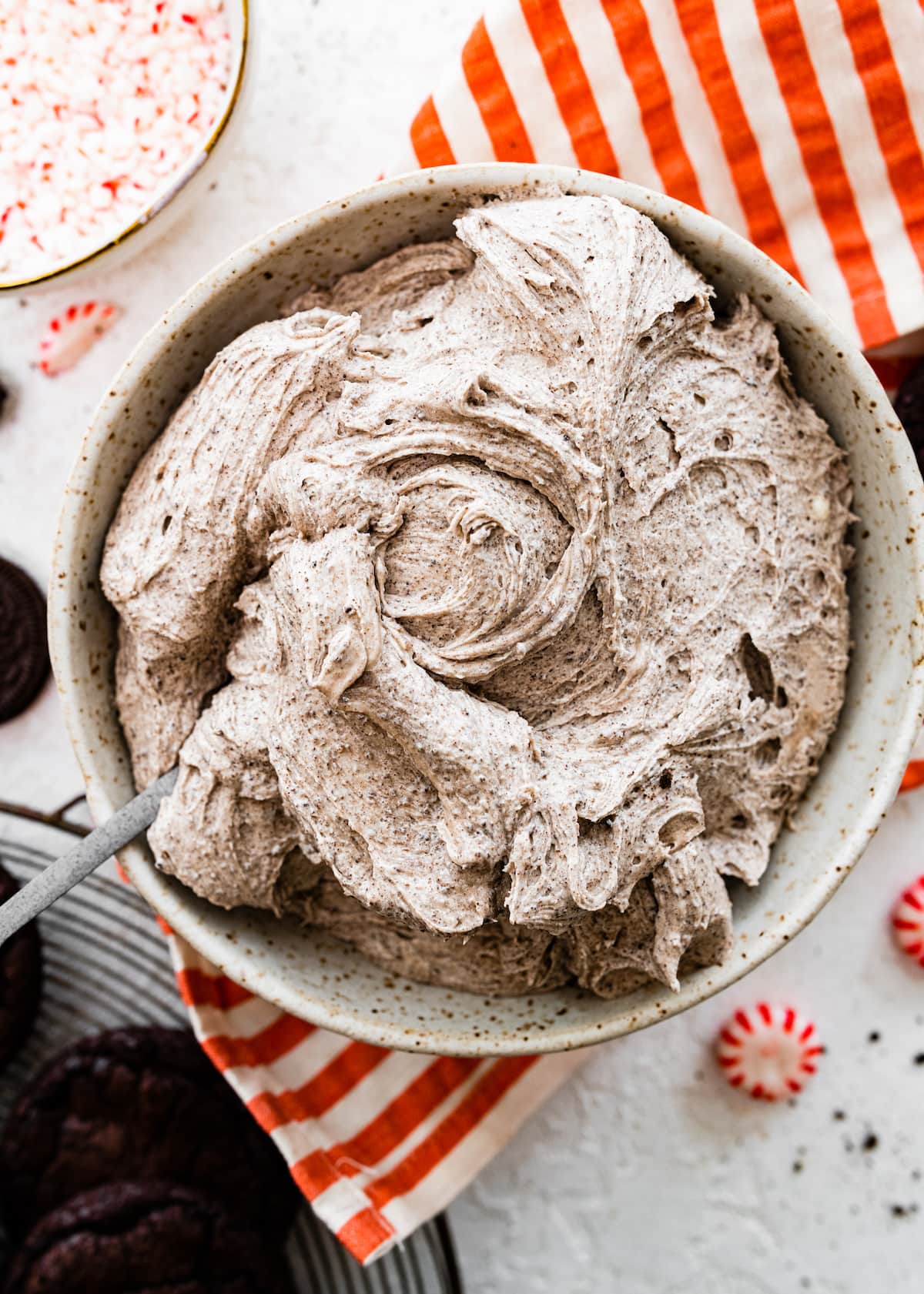 peppermint Oreo cream cheese filling in mixing bowl with spoon. 