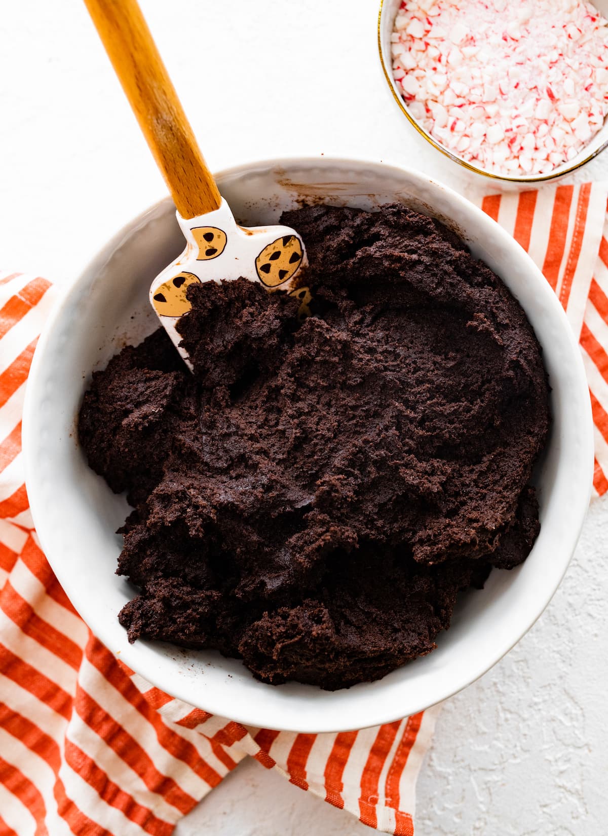 homemade Oreo cookie dough in mixing bowl with spatula. 