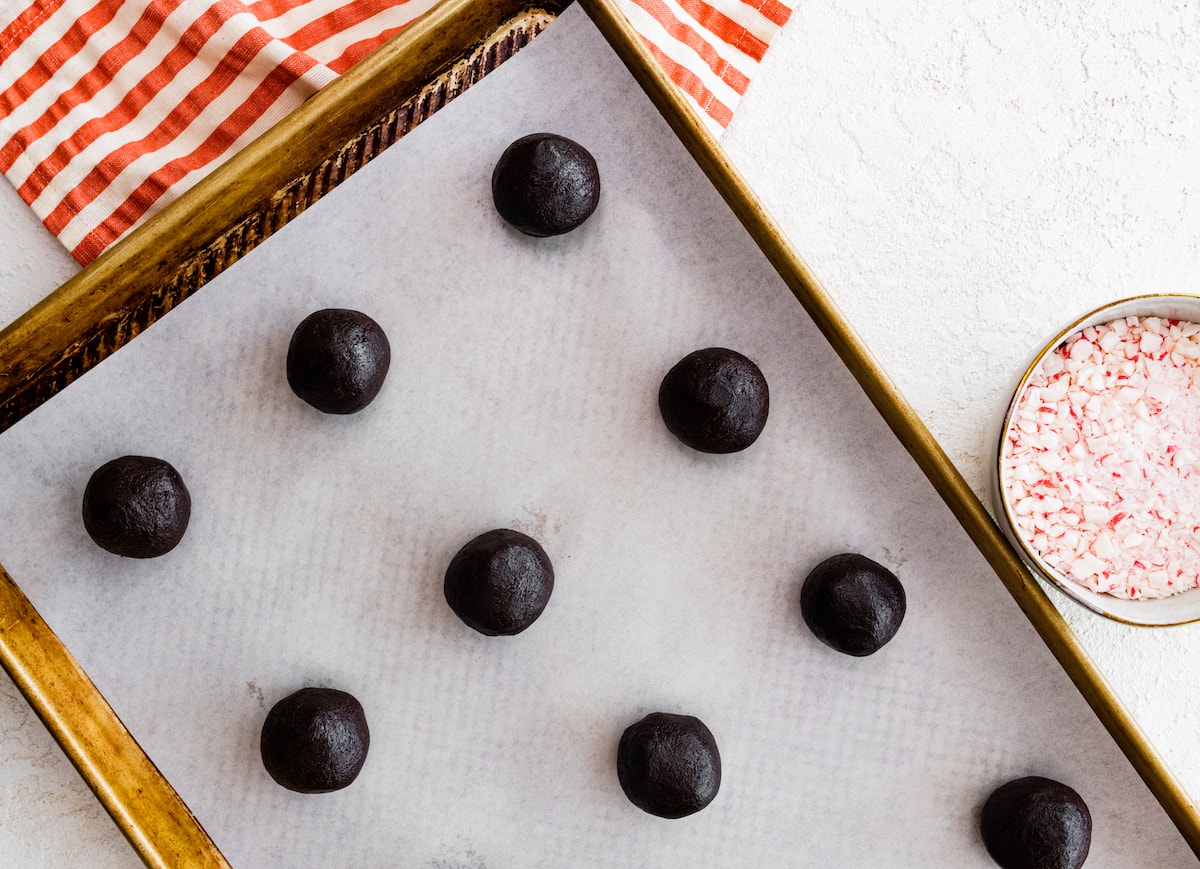 homemade Oreo cookie dough balls on baking sheet with parchment paper. 