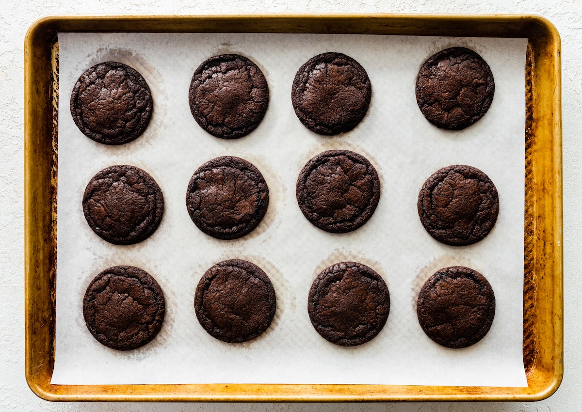 homemade Oreo cookies on baking sheet with parchment paper. 