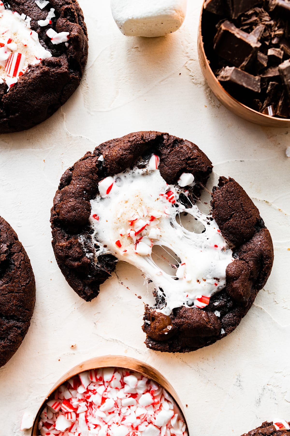 close up of peppermint mocha marshmallow cookie being pulled apart with gooey marshmallow. 