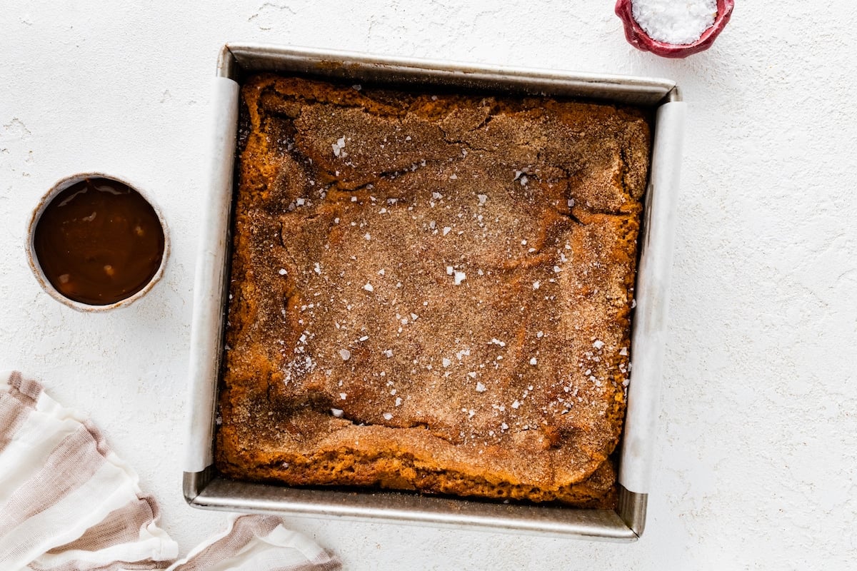 snickerdoodle blondies in pan with flaky sea salt. 