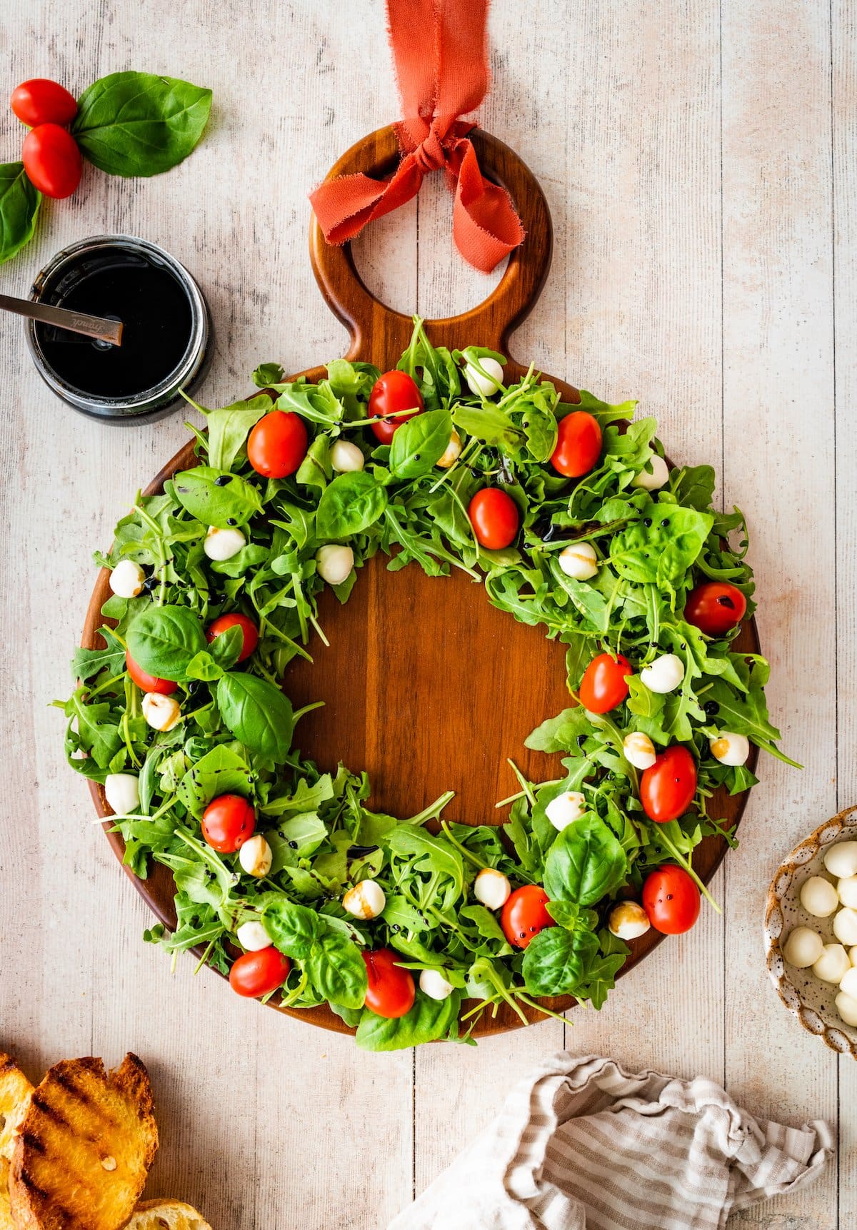 caprese Christmas wreath salad with balsamic vinaigrette in jar. 