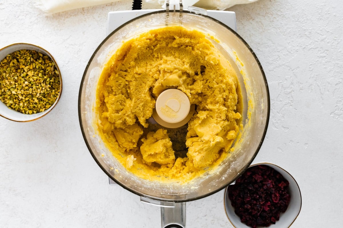 cranberry orange pistachio shortbread dough in food processor. 