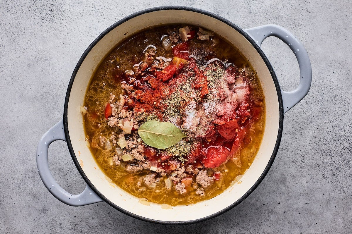 onion, ground beef, tomatoes, beef broth, spices, and bay leaf in large pot. 