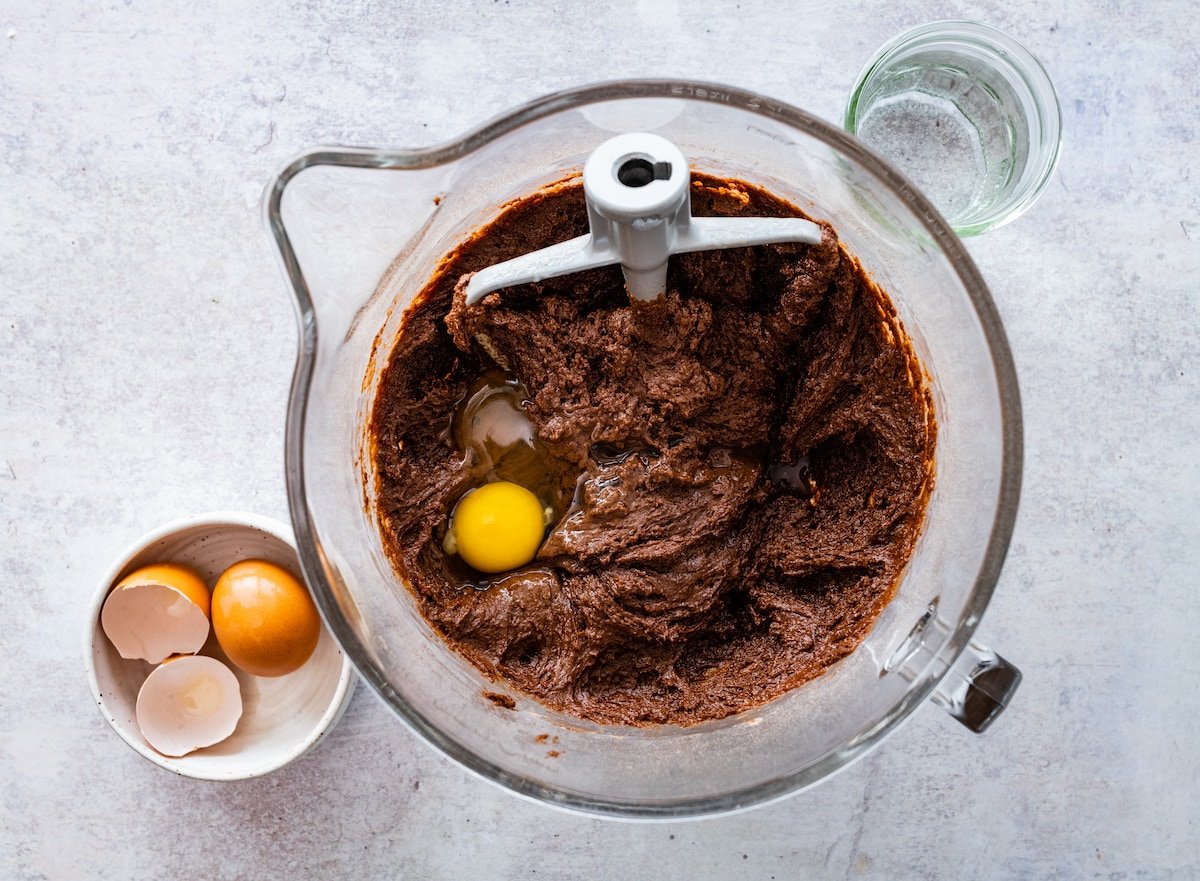 chocolate cake batter in mixing bowl with beater blade. 