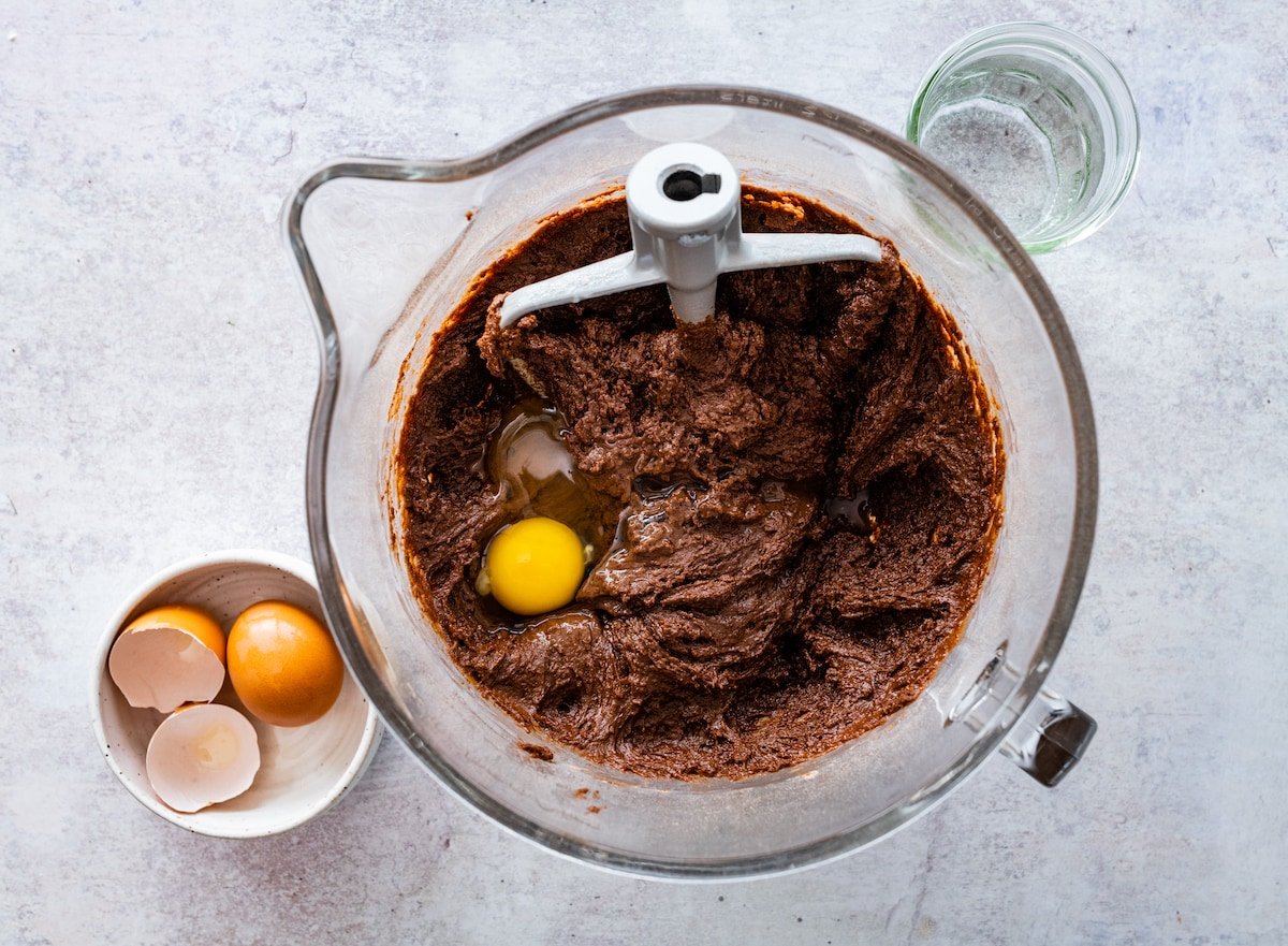 chocolate cake batter in mixing bowl with beater blade. 