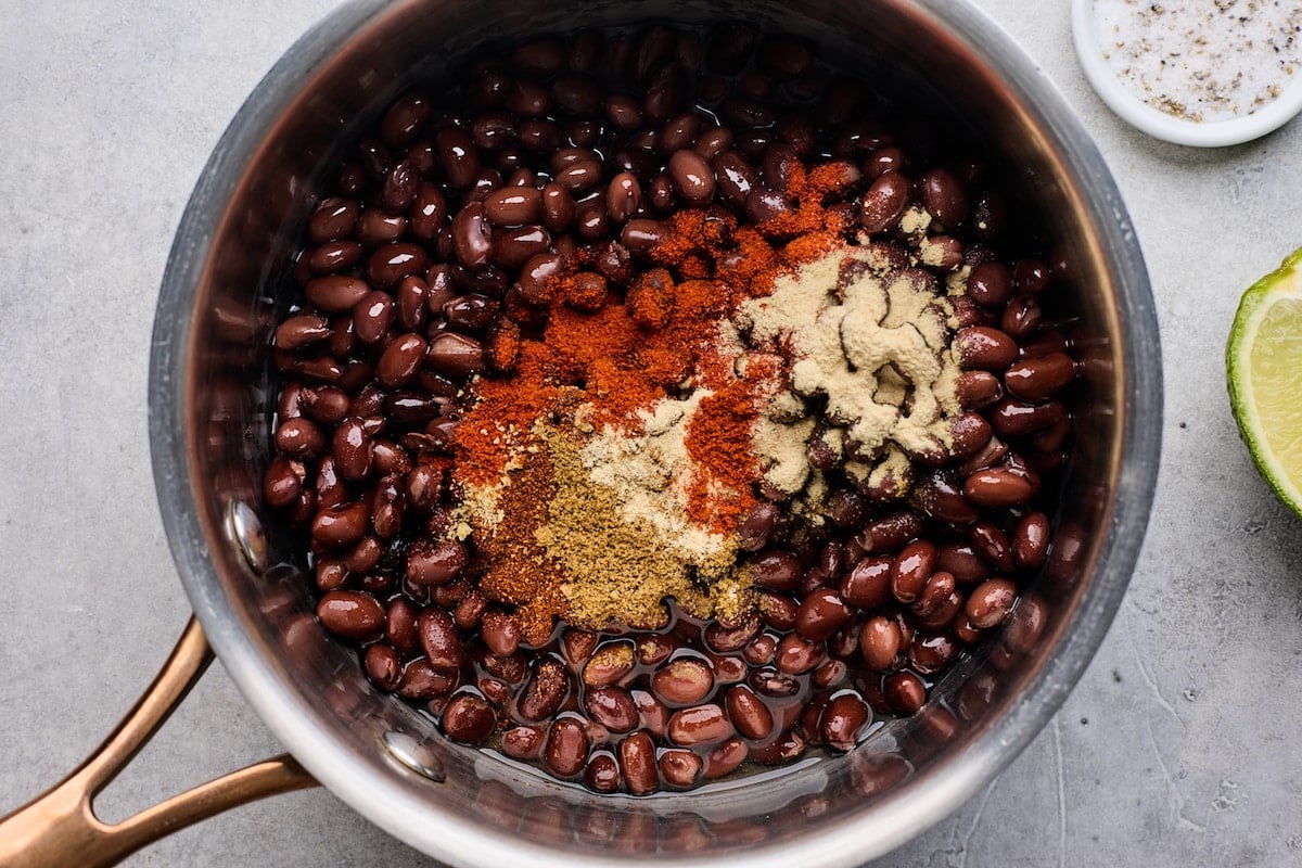 black beans in pot with taco seasoning. 