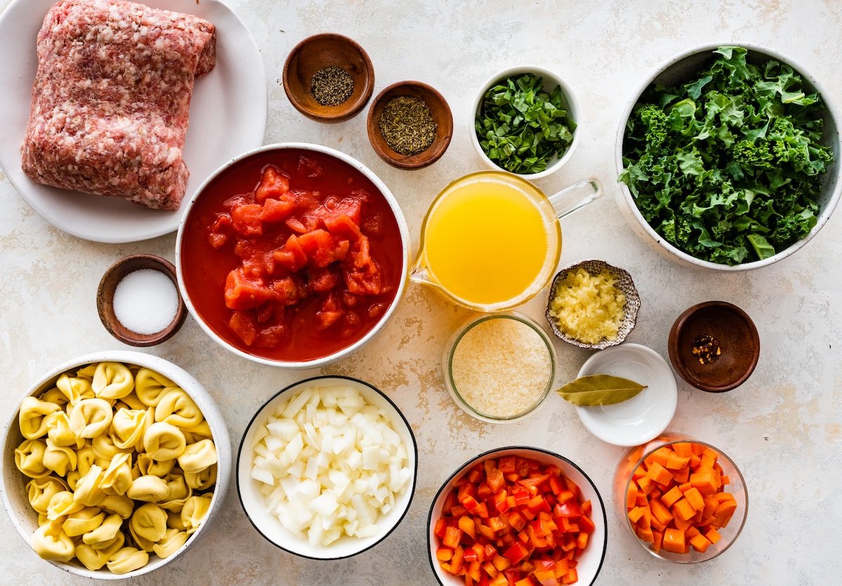 ingredients in bowls to make Italian sausage tortellini soup. 