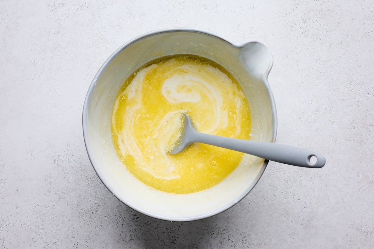 melted butter and buttermilk in mixing bowl with spatula. 