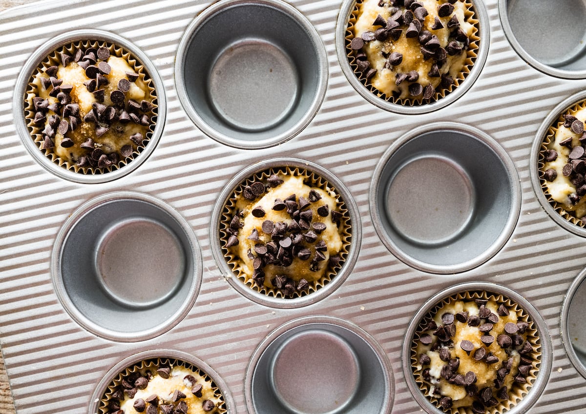 chocolate chip muffin batter in muffin tin. 