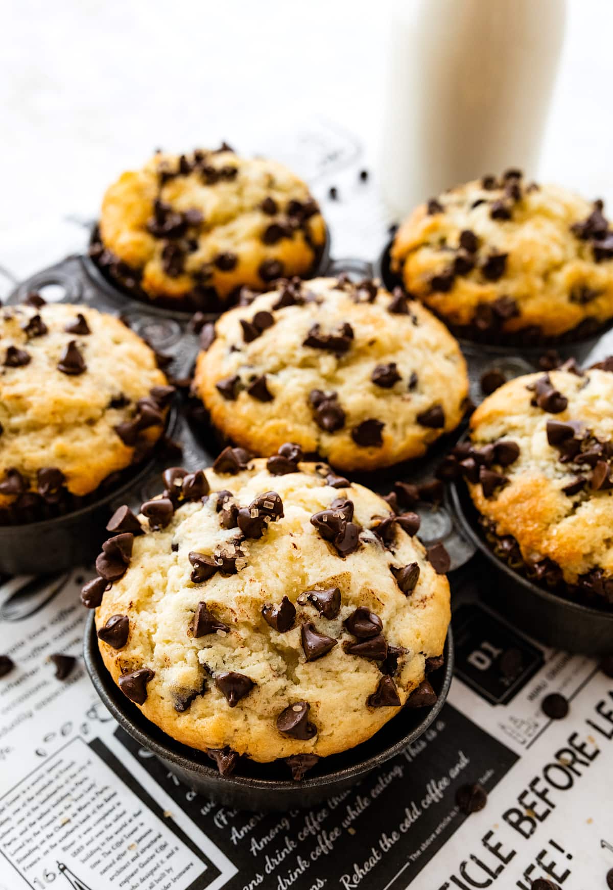 close up of chocolate chip muffin with mini chocolate chips on top. 