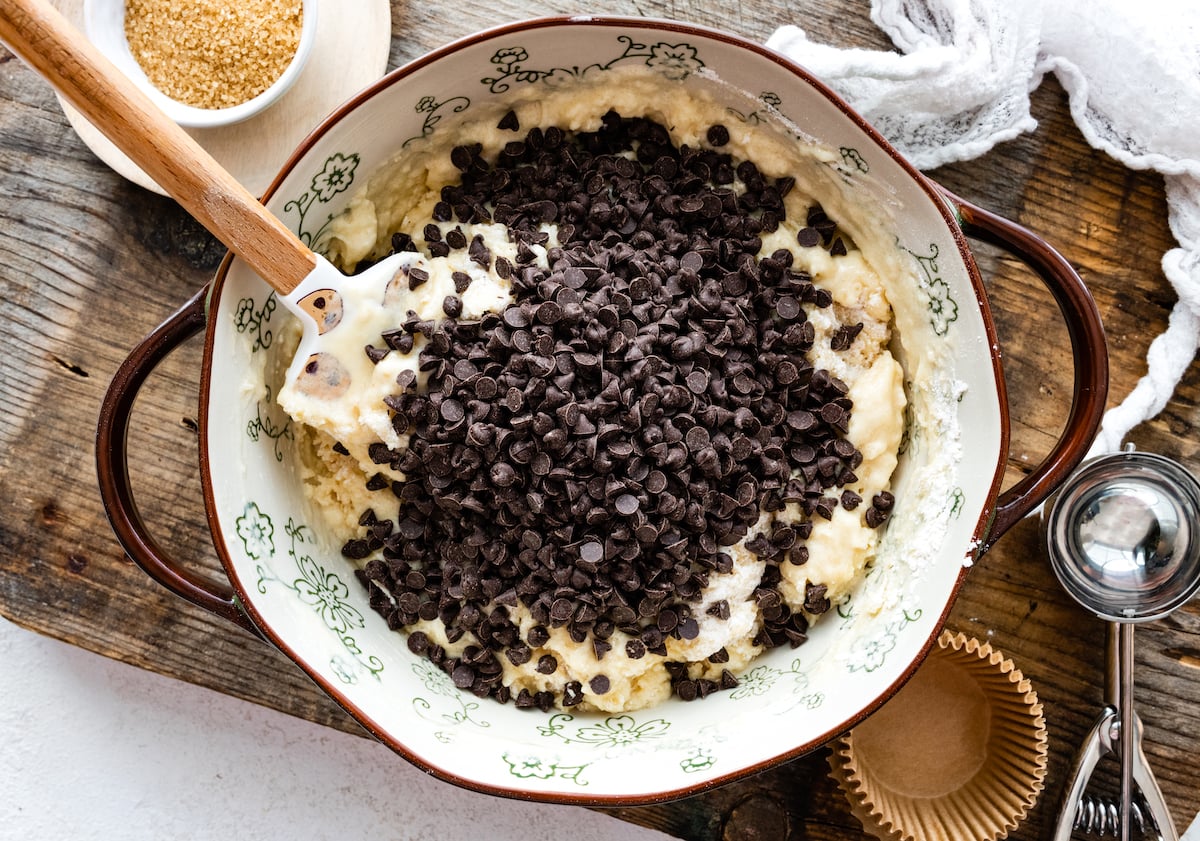 chocolate chip muffin batter in mixing bowl with spatula. 