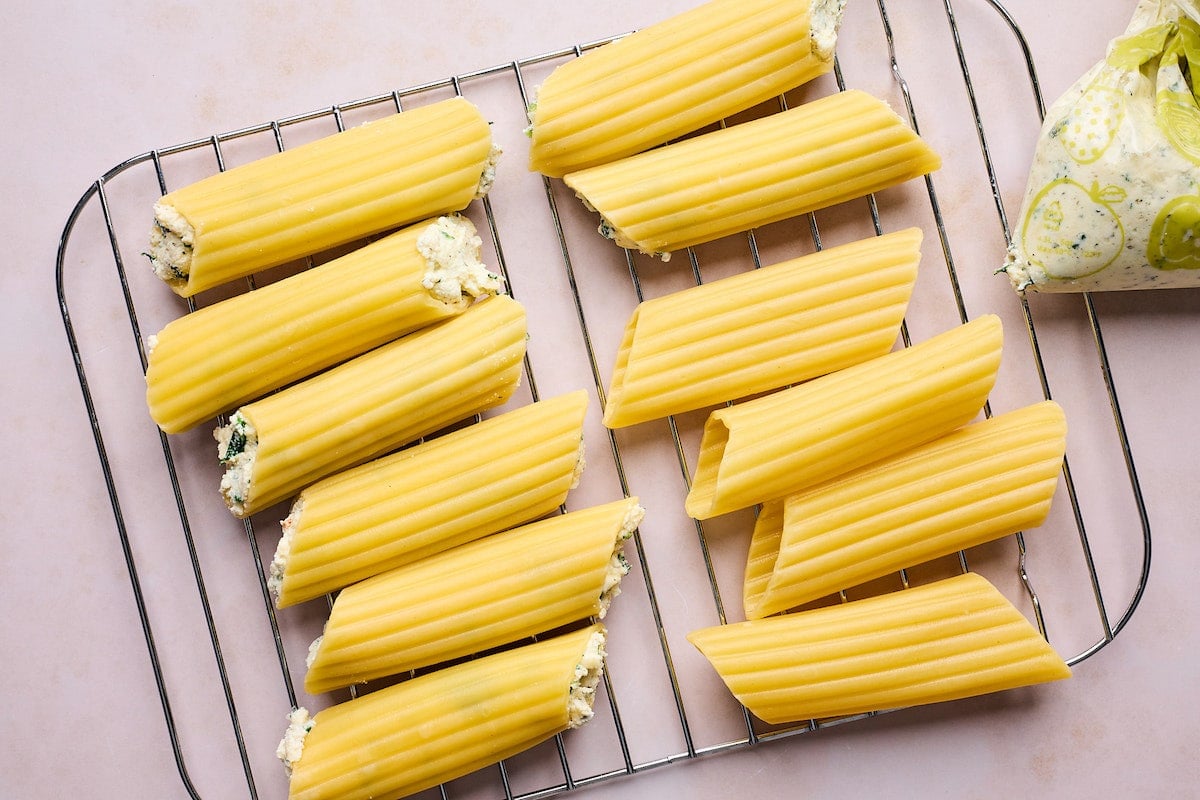 filling manicotti with cheese filling. 