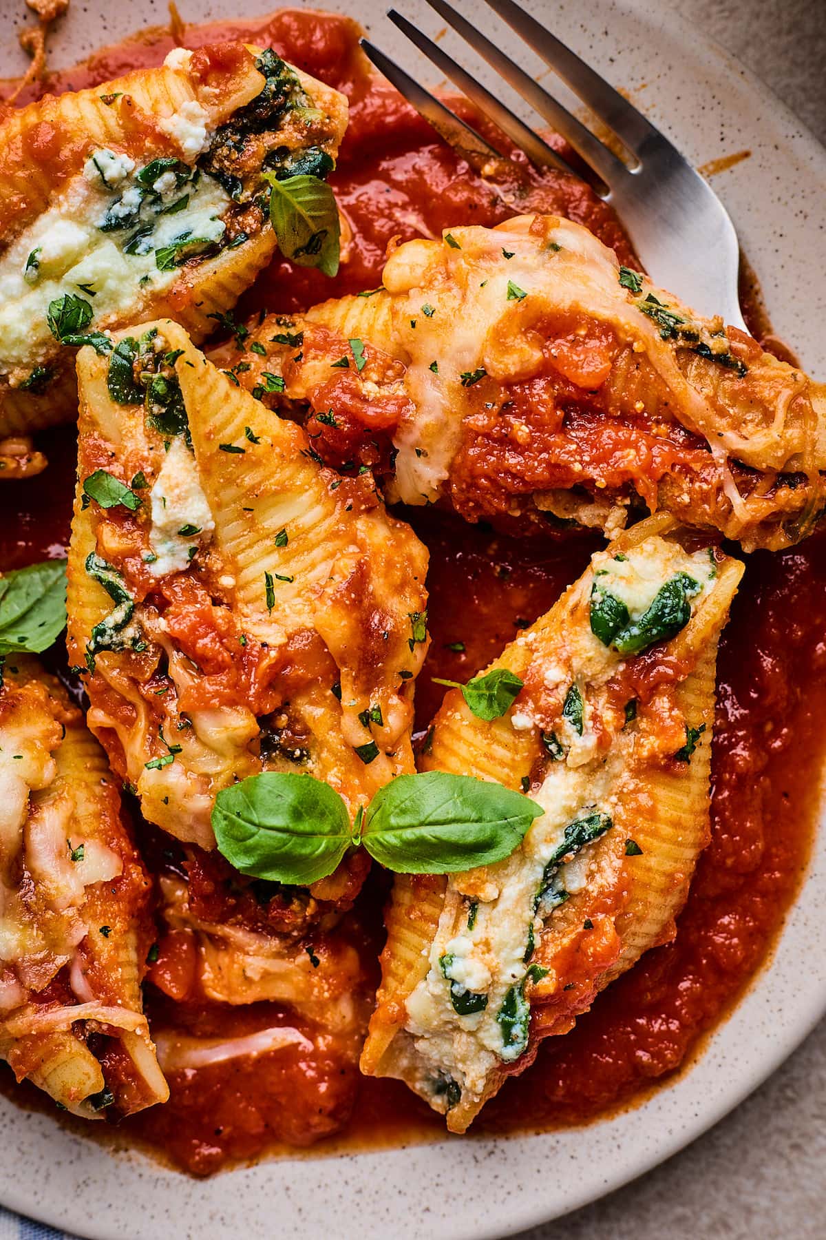 close up of stuffed shells on plate. 