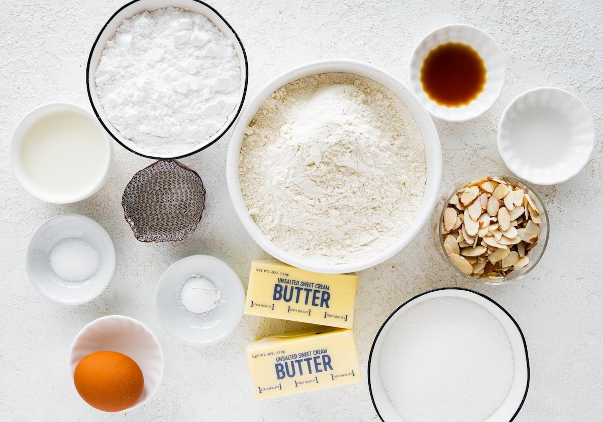 ingredients in bowls to make almond cookies. 