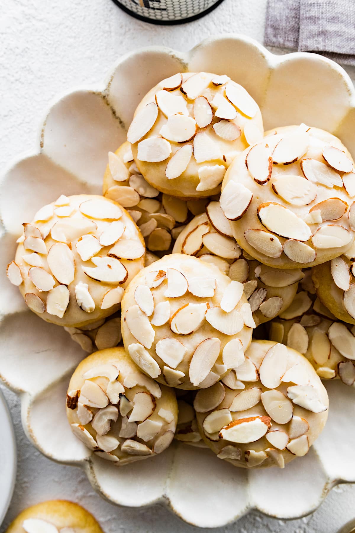 almond cookies with sliced almonds on plate. 