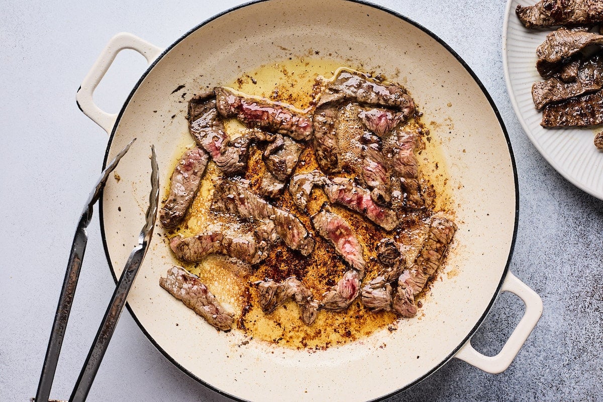 beef cooking in pan to make beef stroganoff.