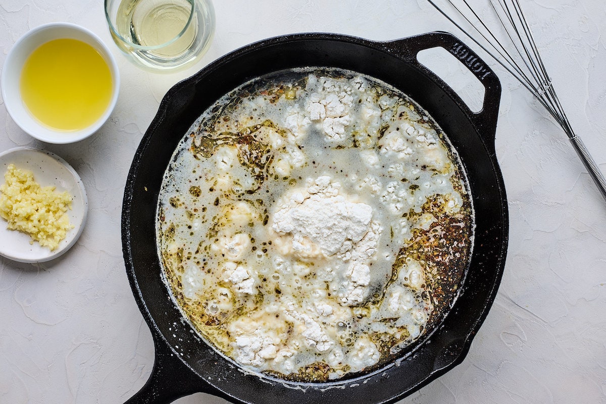 lemon butter sauce in cast iron skillet to make chicken piccata. 