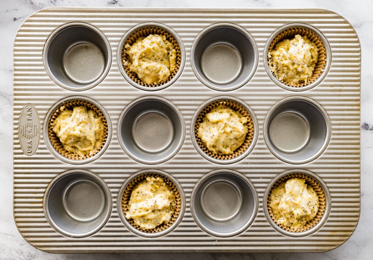 lemon poppy seed muffin batter in muffin pan. 