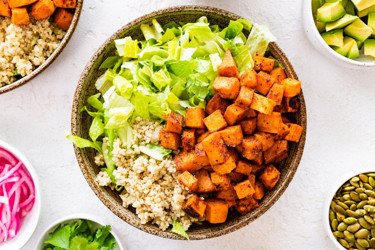 assembling roasted sweet potato black bean bowl/