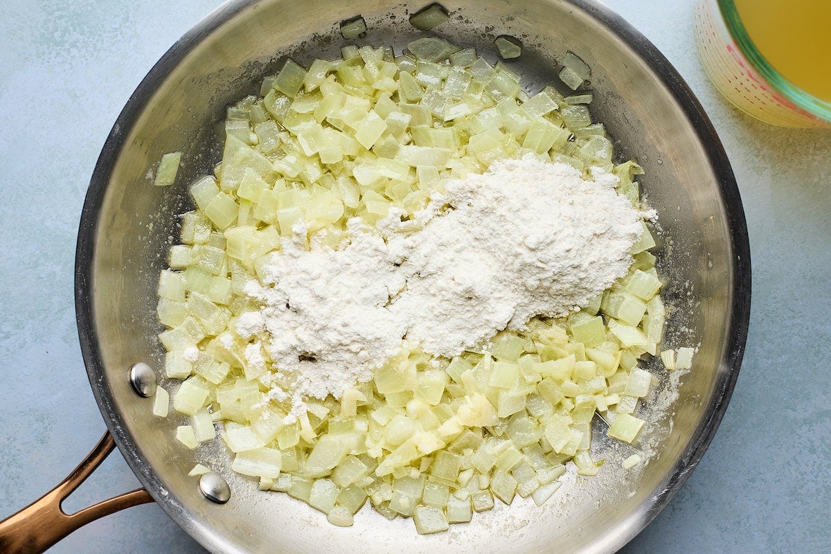 onion sautéing in pan with flour to make sauce for white chicken enchiladas. 