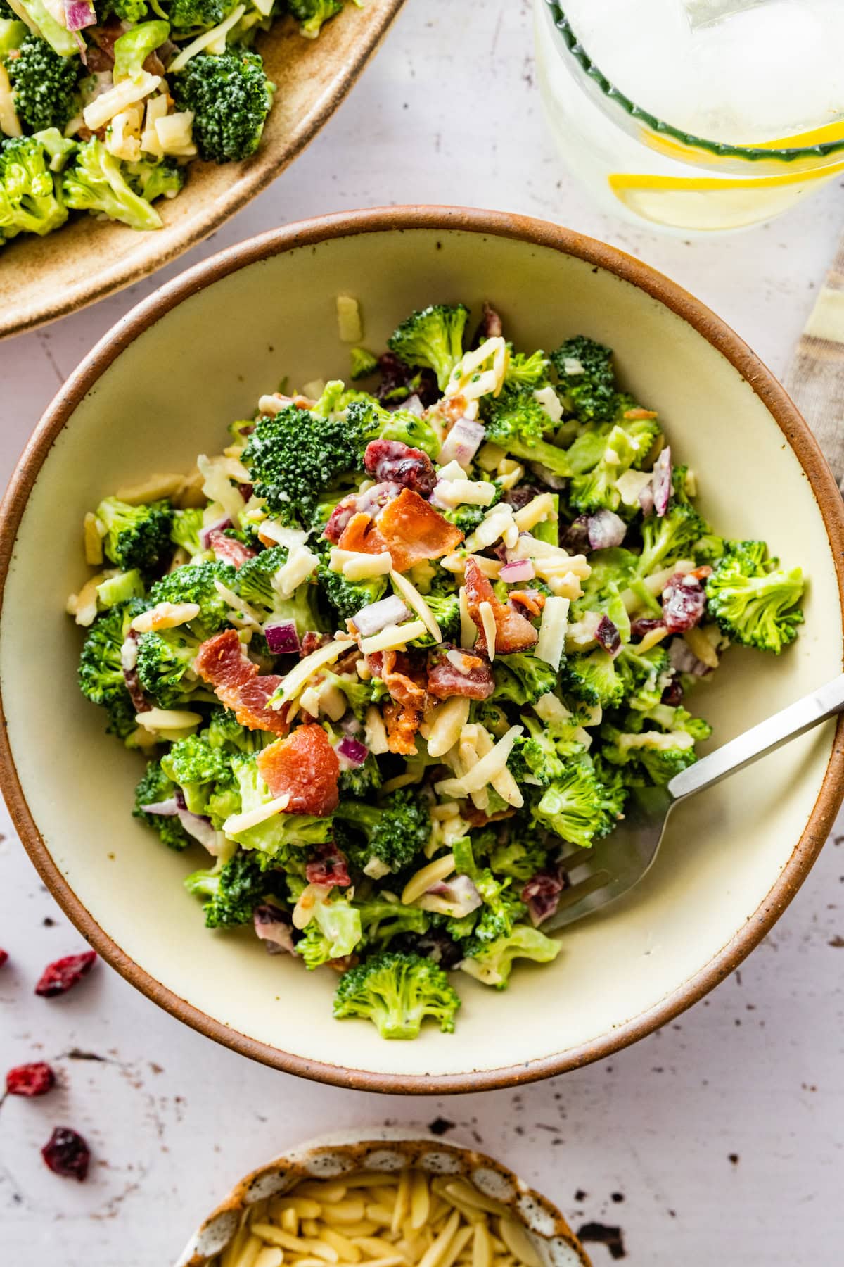 broccoli salad in bowl with fork. 