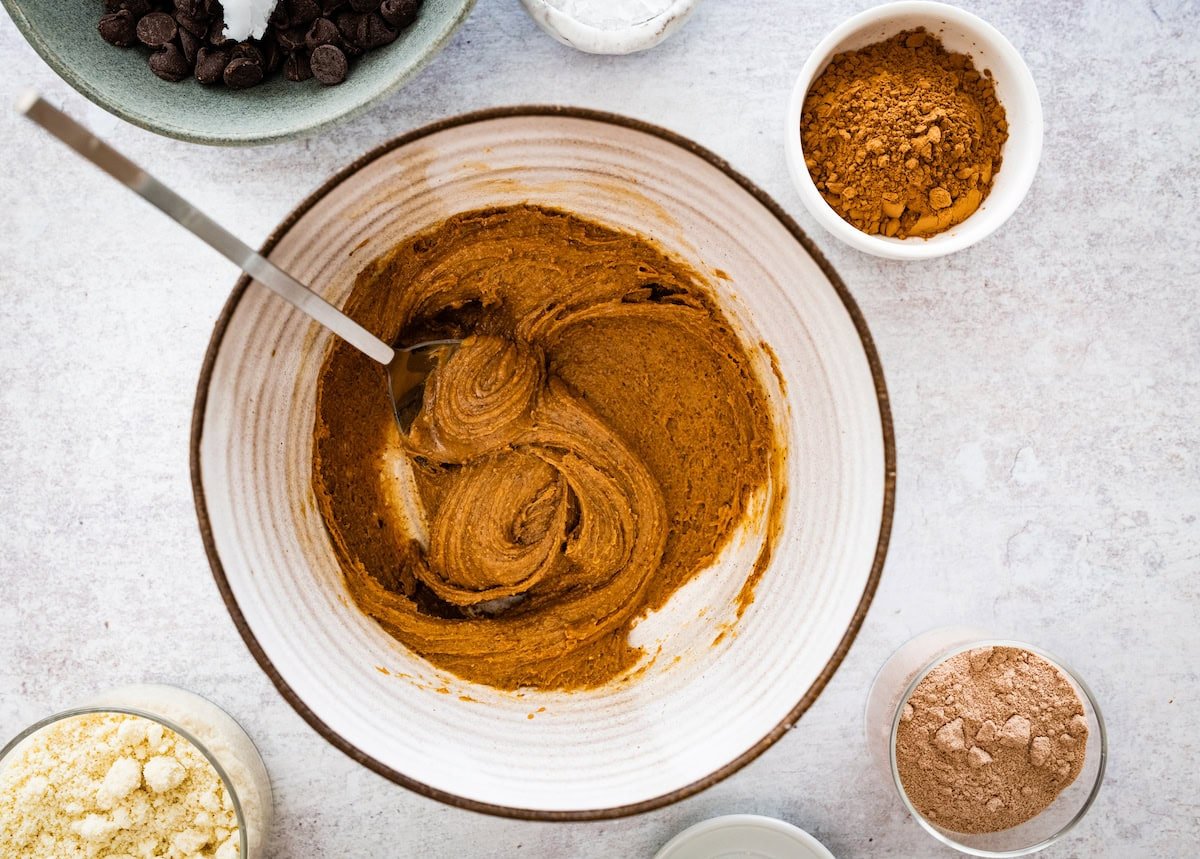 creamy almond butter in mixing bowl with spoon. 