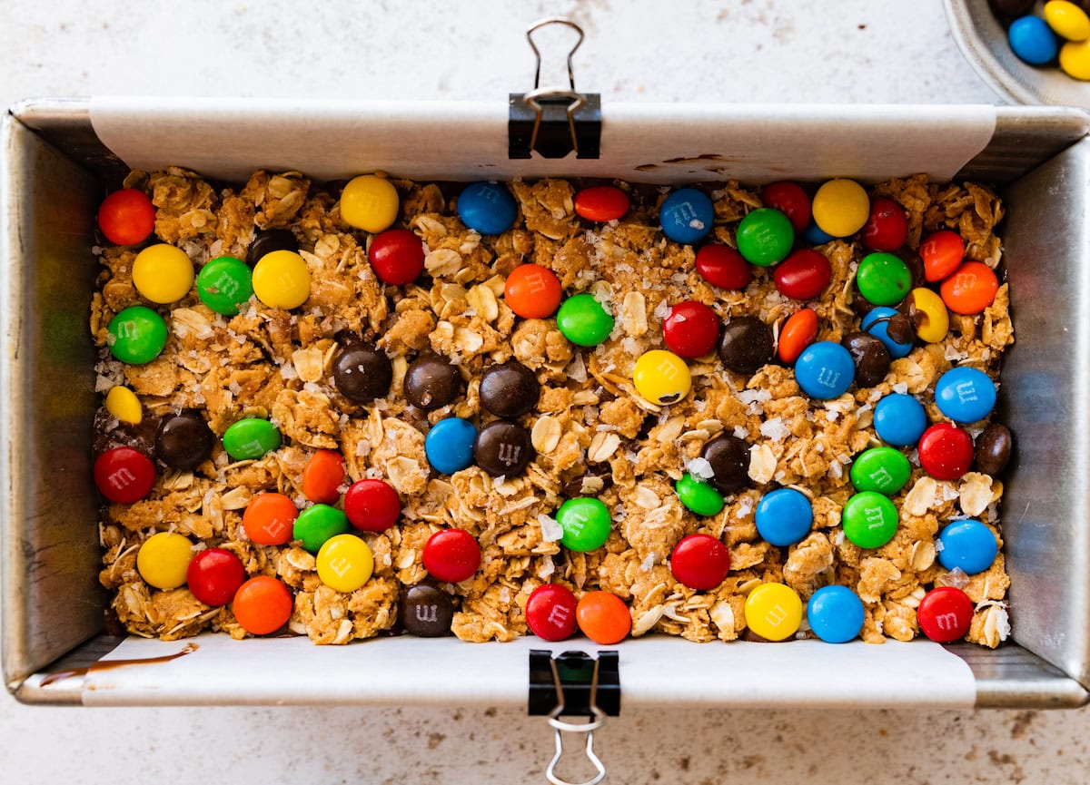no bake monster cookie bars in loaf pan lined with parchment paper. 