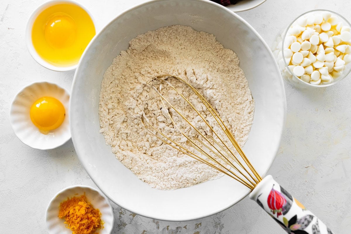 dry ingredients being whisked together in mixing bowl. 