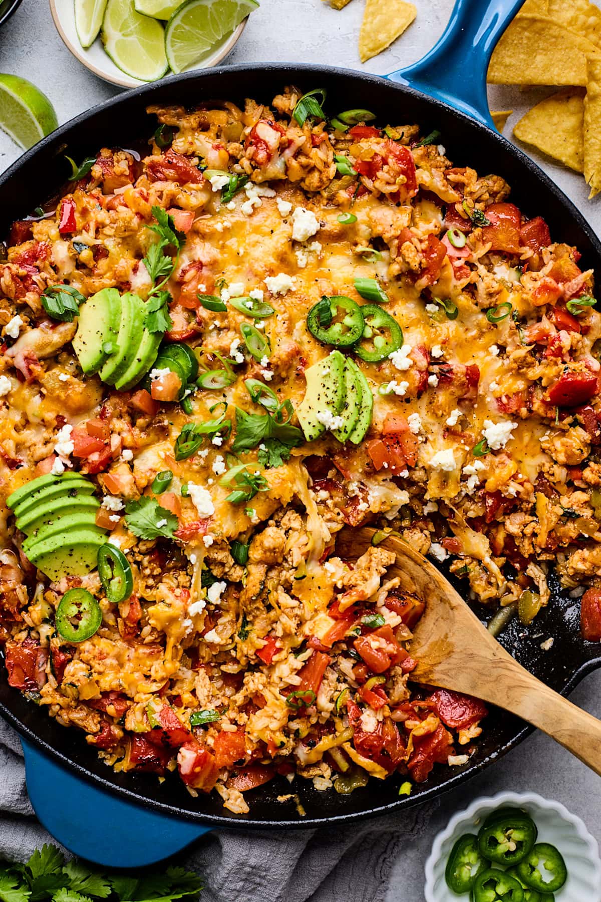 ground turkey taco skillet being served with wooden spoon.