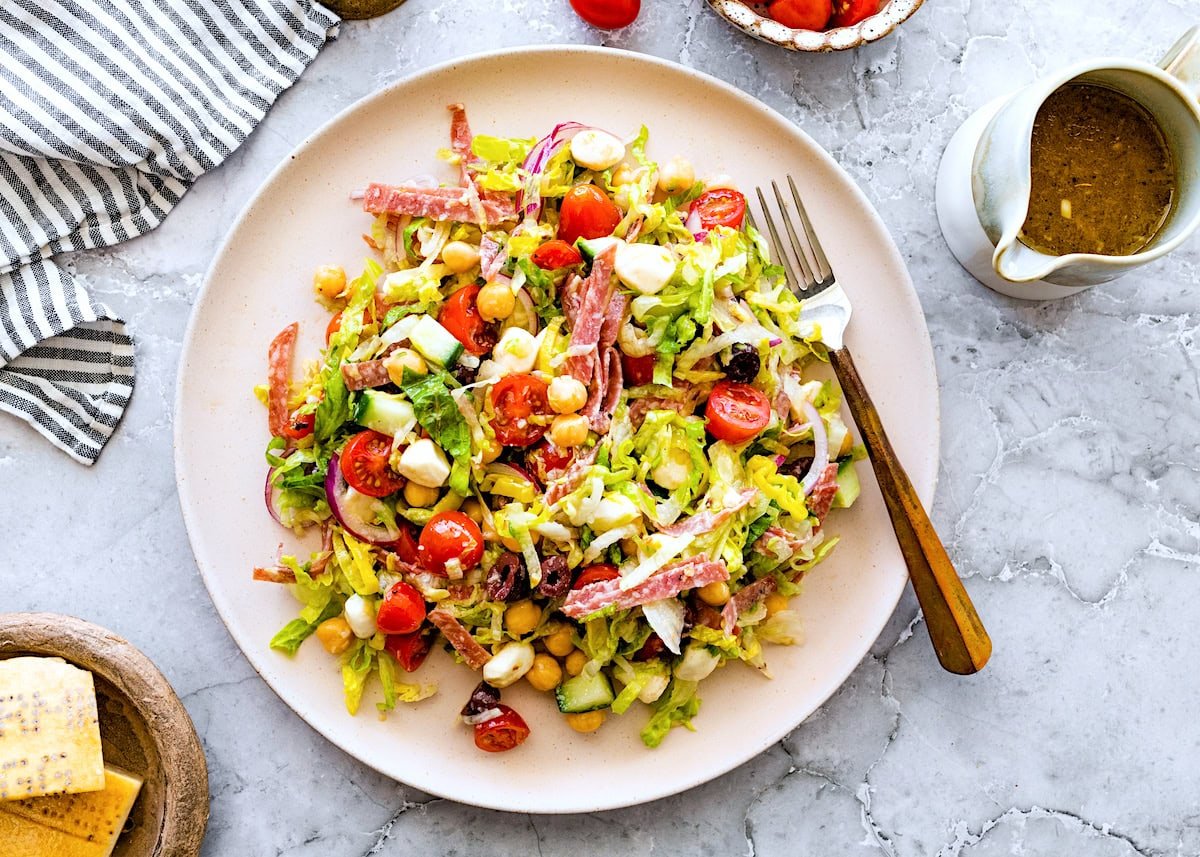 Italian chopped salad on plate with fork. 